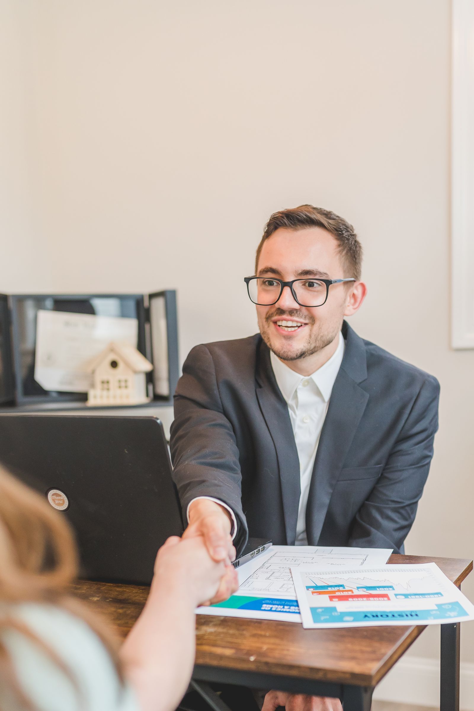 An agent welcoming a client to the office
